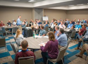 A group of employees sitting in a room investing in Career Development at Halff's Annual Leadership Forum 2024